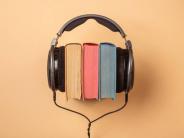 Image of headphones on 3 books.