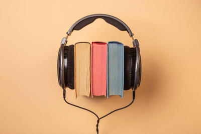 Image of headphones on 3 books.